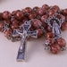 handmade Catholic rosary in silver with mottled mauve glass beads