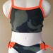 Girl swimsuit green camouflage with bright orange trim