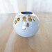 white ball vase with gold dots