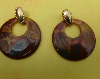 Large circle earthtone pierced earrings.