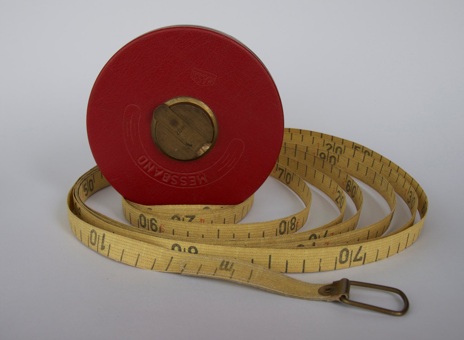 SALE Vintage German measuring tape in a red leather case.