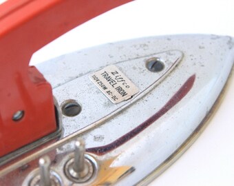 Vintage metal Ziffco foldable travel iron with red handle