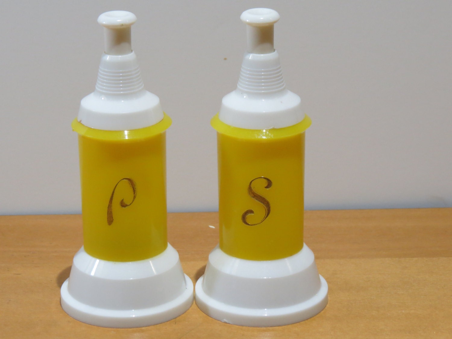 Yellow push top salt and pepper dispensers Haute Juice