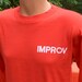 80s vintage t-shirt IMPROV theater nyc new york hells kitchen comic long sleeve tee shirt Medium Large red