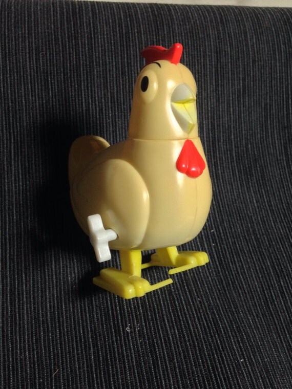 Vintage windup chicken toy walks and lays candy eggs