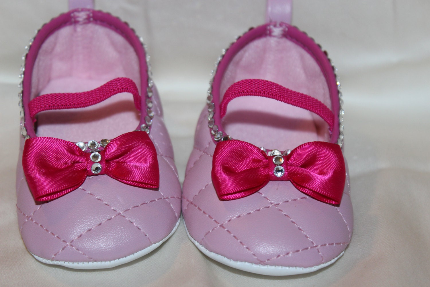 Light pink baby girl shoes with hot pink trim and bow and