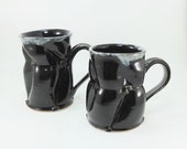 pair of black mugs sold together