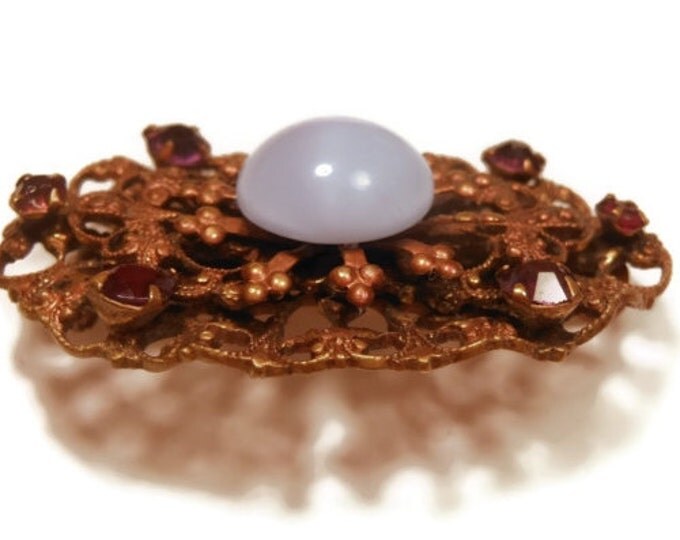 1940s Coro brooch, blue moonglow cabochon brooch with filigree scroll work and amethyst rhinestones, gold tone