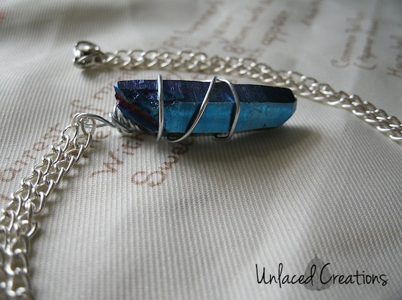 ellai. a wire-wrapped blue titanium quartz pendant on silver chain.