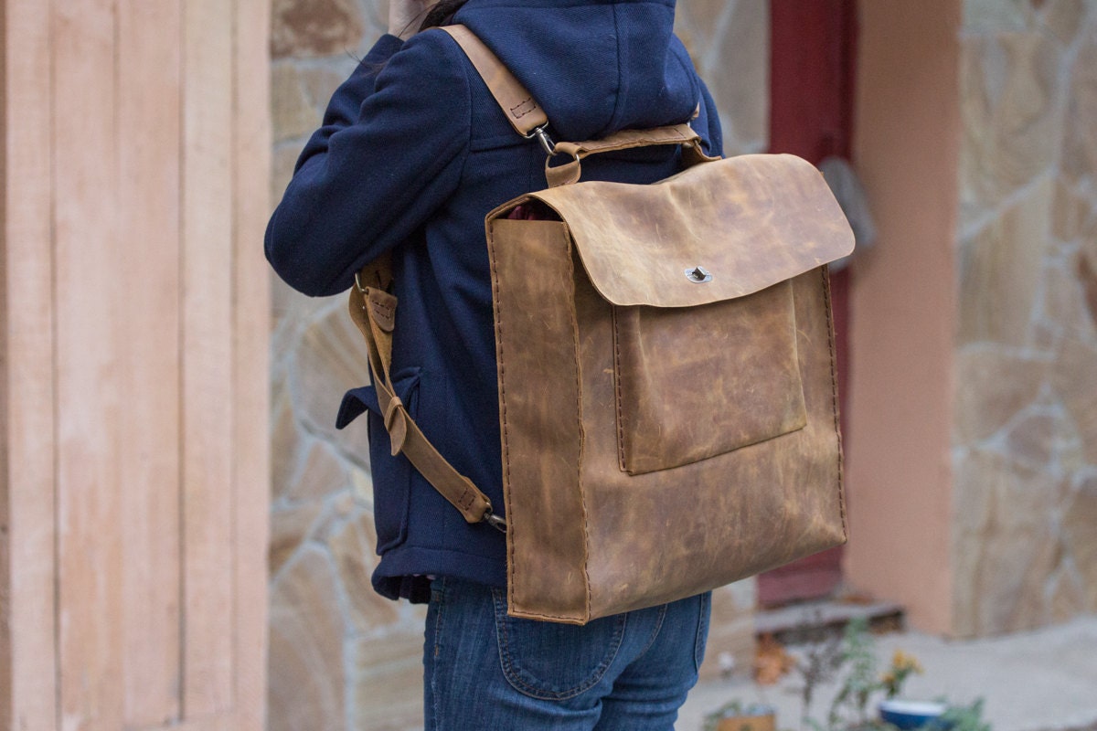 Hand stitched leather rucksack backpack in light brown pull up