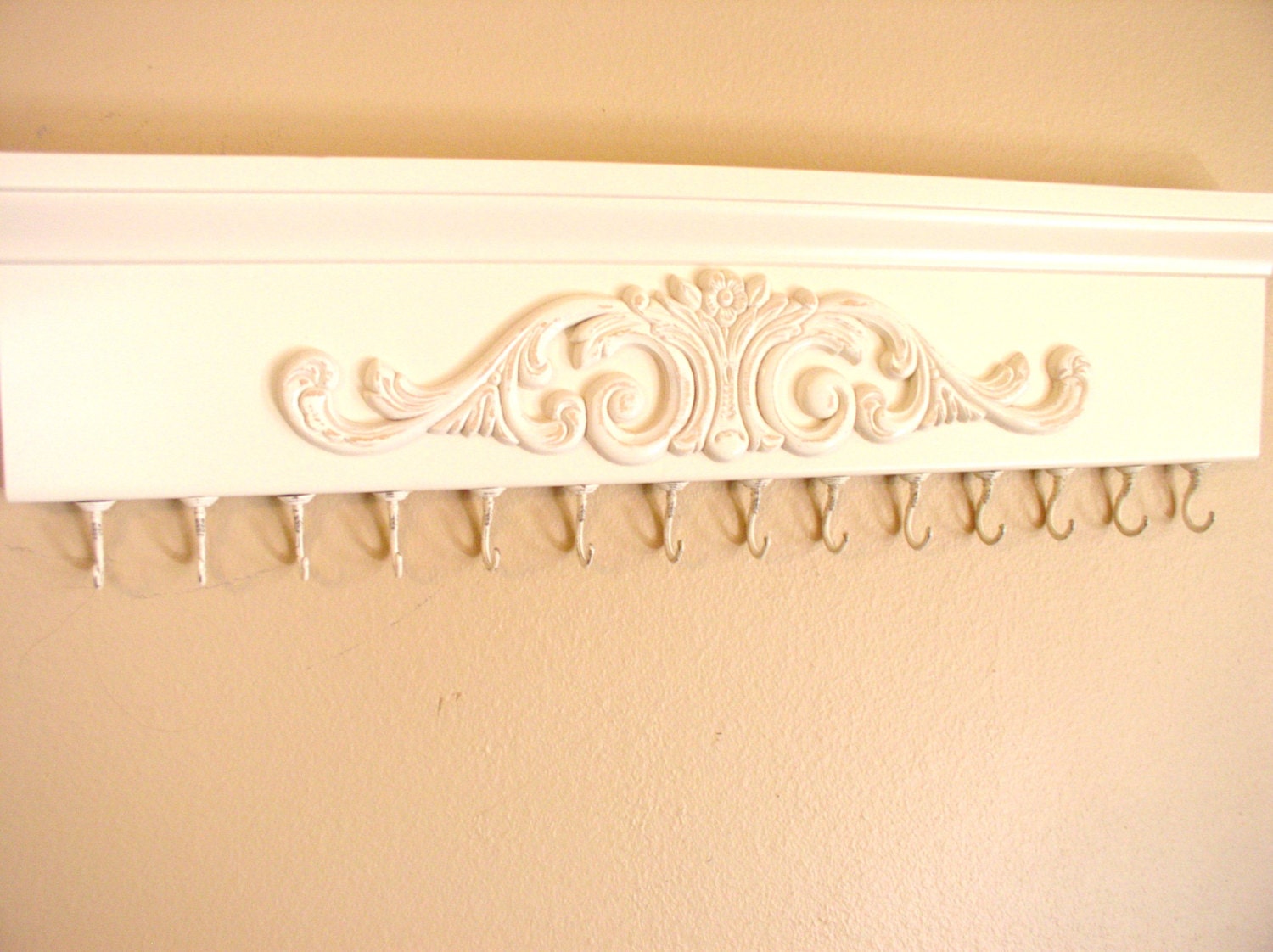 Decorative x Large hooks make this wall hung Jewelry rack Very