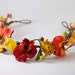 Pansies of red and orange with green accents fairy, bridal, woodland head piece