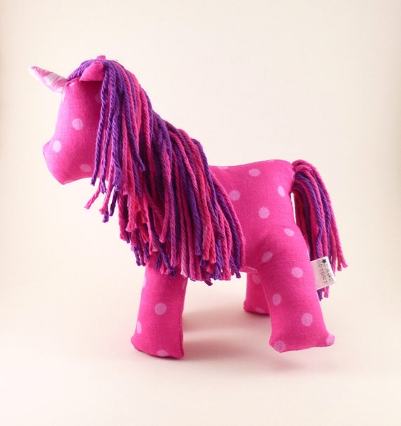 Pink polka dot stuffed unicorn toy with purple and pink hair