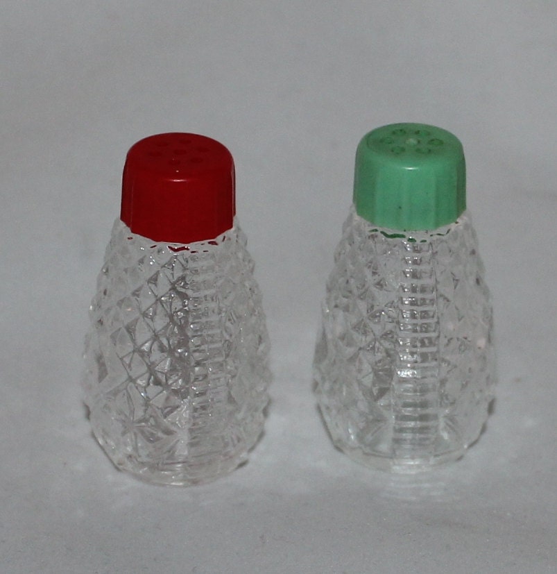 salt and pepper shakers with red and green plastic tops individual size