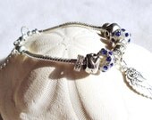 Silver Wing Charm Bracelet with silver wing charm and blue rhinestone european charms.