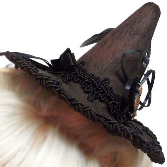 woman wearing tiny witch hat