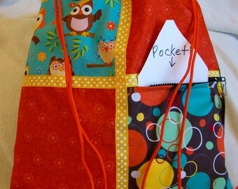owls with orange and gold accents on a brown ripstop nylon drawstring backpack with front zipper pocket