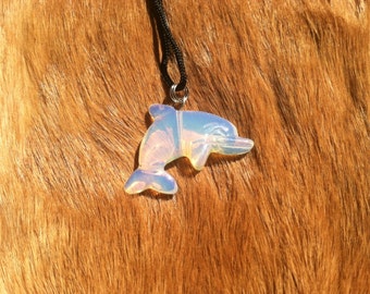 Carved stone dolphin necklace. Made of moon stone.