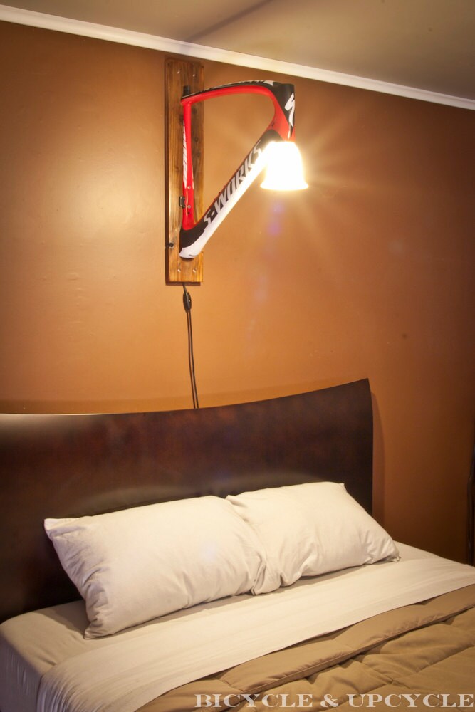 Unique handmade upcycled bike frame wall lamp. Recycled bike