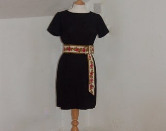 Classic 1950's vintage figure hugging black linen wiggle dress with a gorgeous flower pattern embroidery tie waist detail