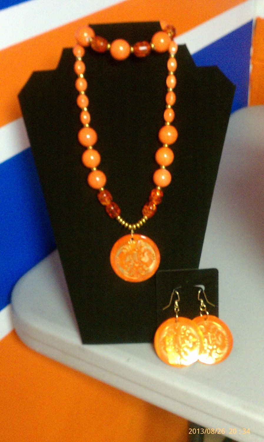 Orange three piece costume jewelry set. This beauty is made