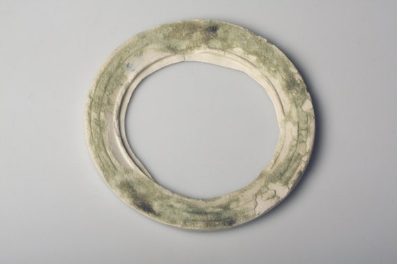 Round  frame from Royal porcelain in an ivory color by madebymanos