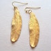 Gold Feather dangly earrings - long textured feathers - brass feathers