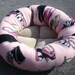 Dog bed or cat bed 21 inch in a pink fleece with leopard and tiger print shoes and purse on it.
