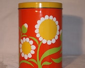 Bright orange tin canister with large white and yellow flowers, 70s, J. L. Clark