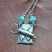silver can of sardines necklace with aqua lamp work beads
