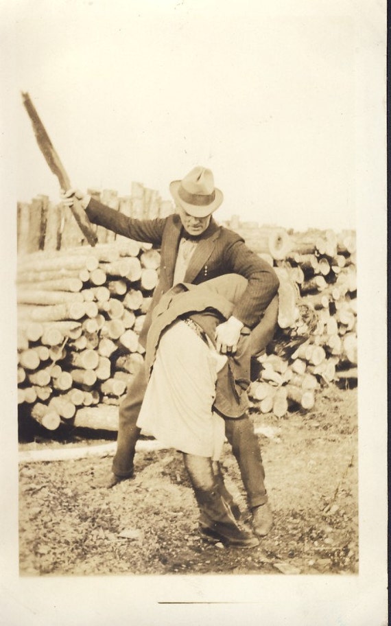 Man Is About to SPANK Young Woman with a PIECE of WOOD Photo