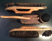 Collection of antique wooden shoe brushes with natural hair bristles