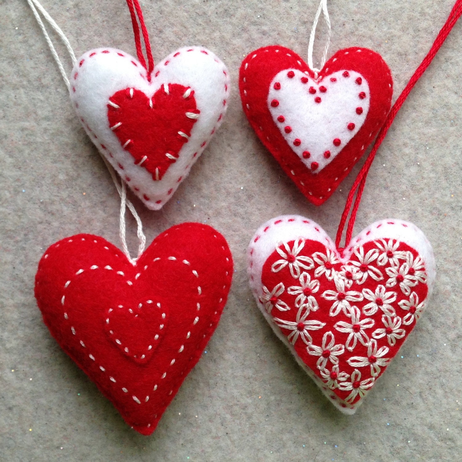 Red and white embroidered felt heart ornaments by Lucismiles