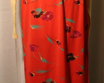 Red patterned floral skirt with side hem slits. 1960s/70s