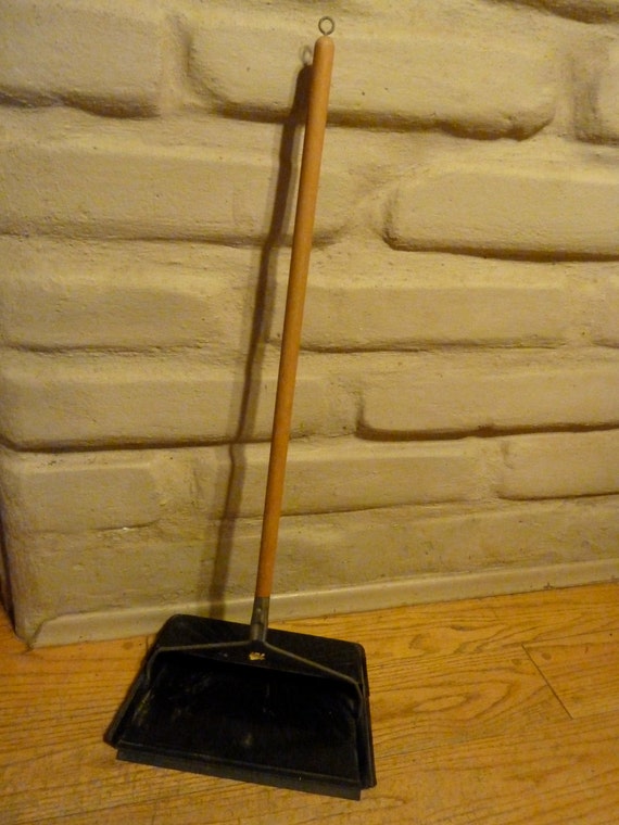 Vintage swiveling metal dust pan with extended wooden handle