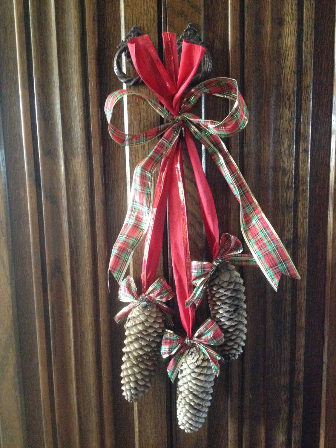 Pinecone Hanging on a bright Red Ribbon with Red, Green and Gold bows