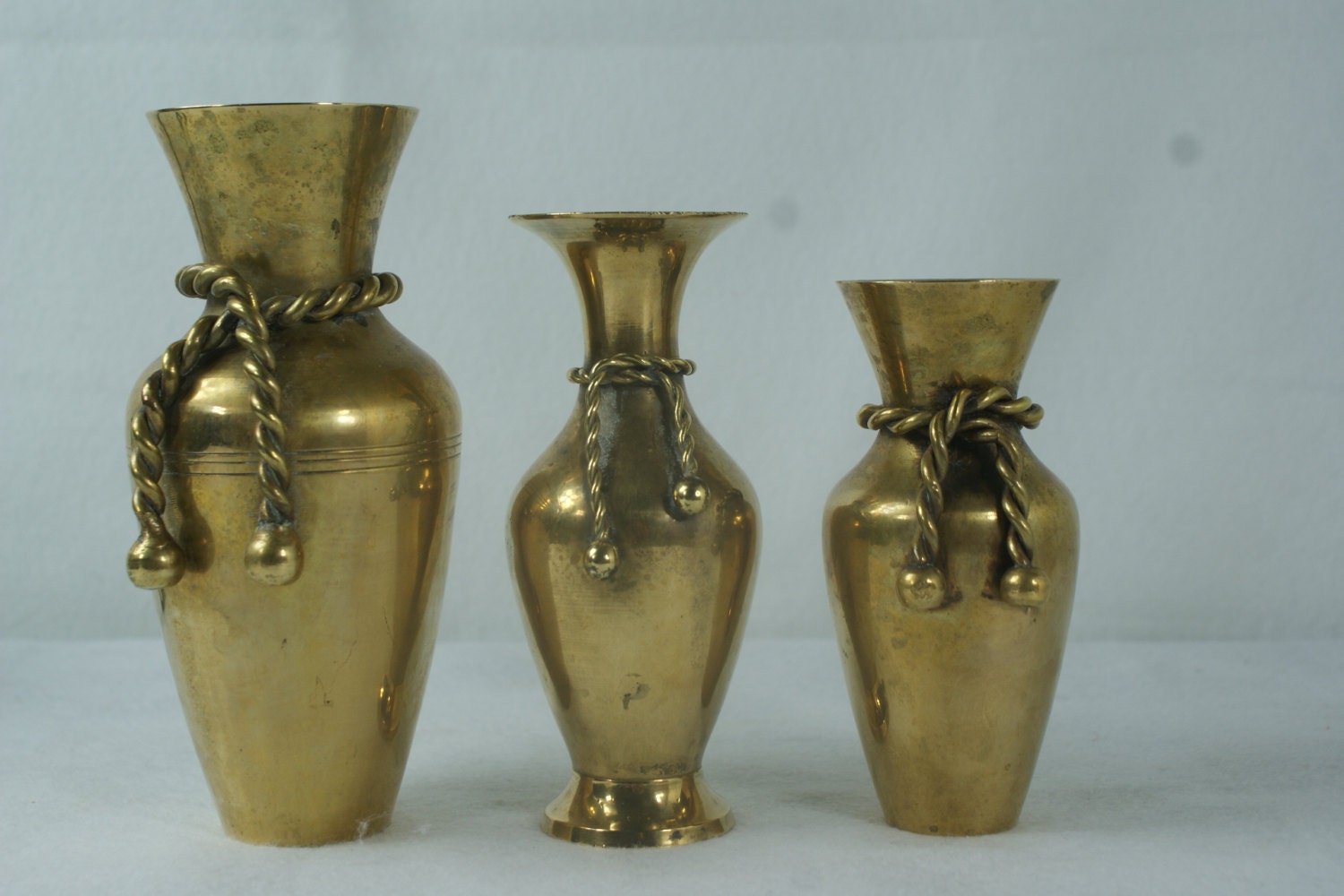 Trio of Brass Vases. Rope and Tassel Details. Brass Vases.