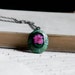 pressed flower necklace. real pink daisy floral on green filigree verdigris patina filigree bezel nature natural resin necklace jewelry