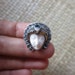 Silver Ring Moon Face Cow Bone Carving with Gold Plated Edging and Blue Topaz