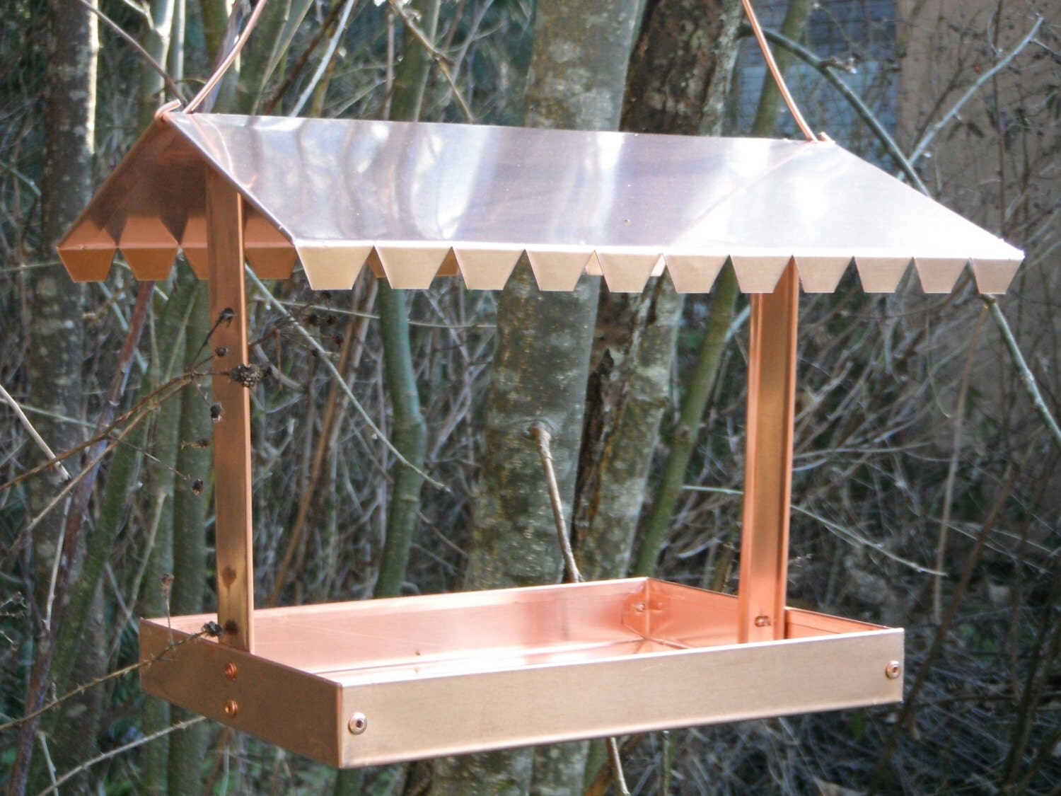 Solid copper bird feeder.