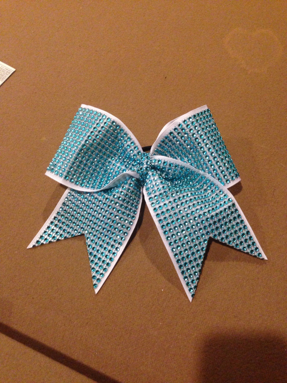 Teal rhinestone bow on white ribbon