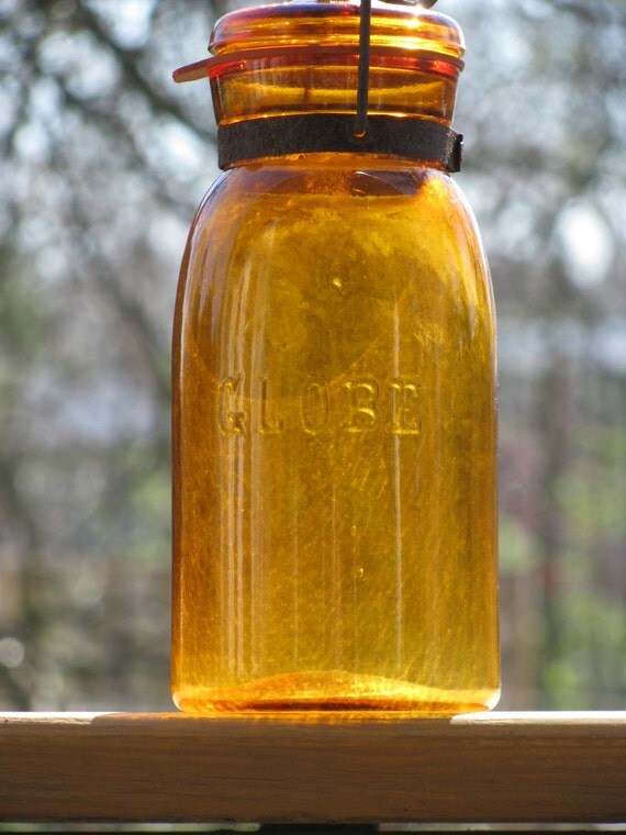 Amber Globe Canning Jar with lid and bail.