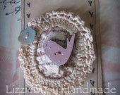 Stitched brooch with crochet tea dyed frame  and hanpainted button pink bird with dots