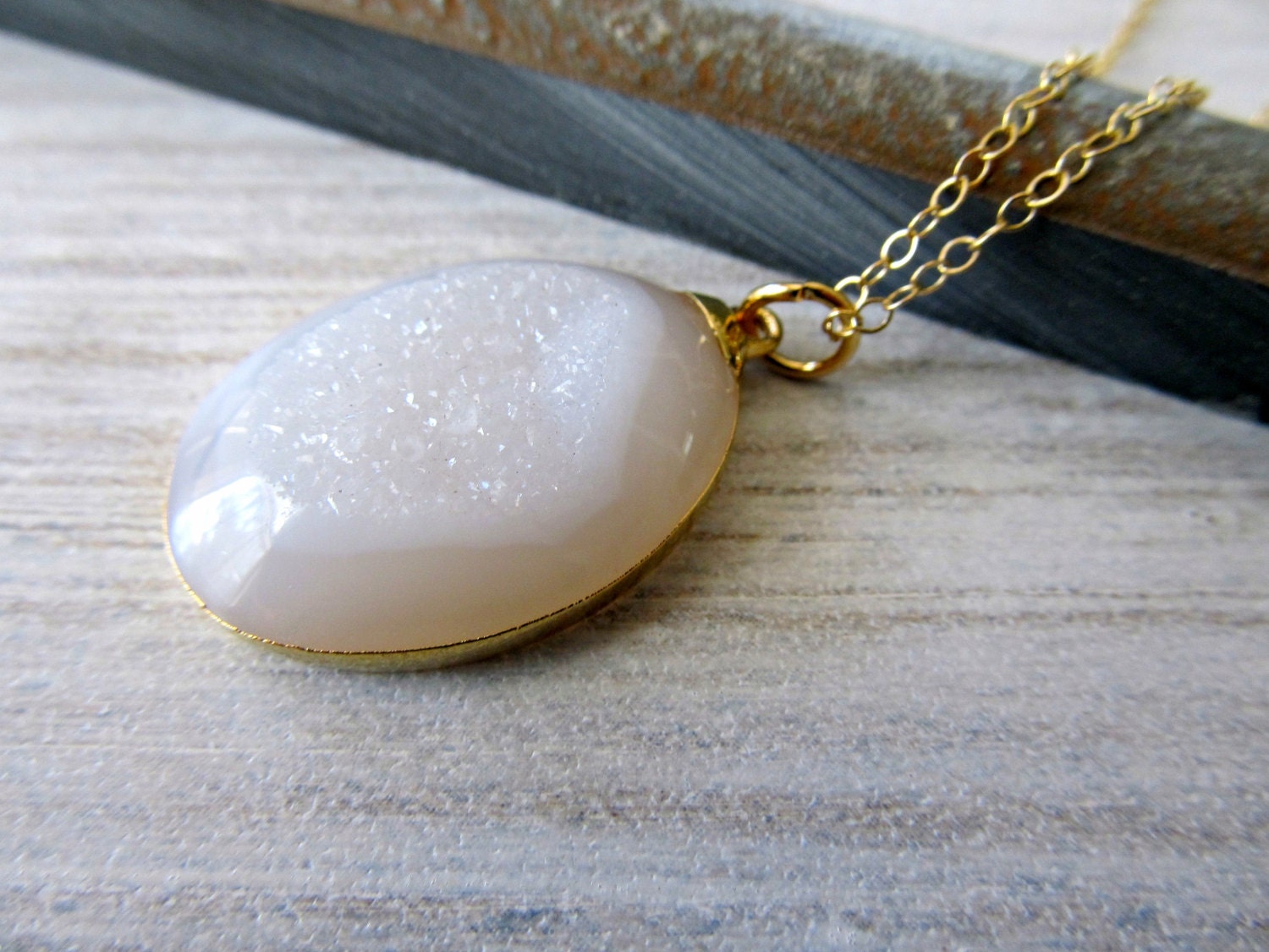 White druzy pendant necklace set in gold on a gold filled