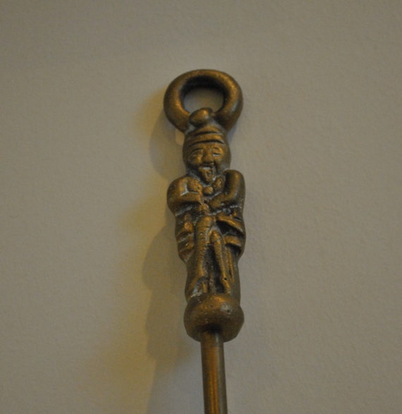Vintage brass fire poker Decorated an Oriental style man