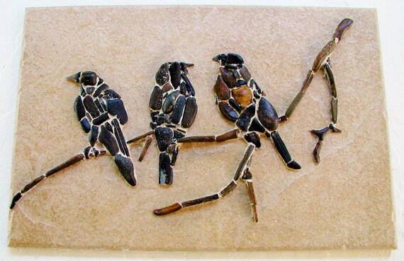 three sparrows sitting on a twig