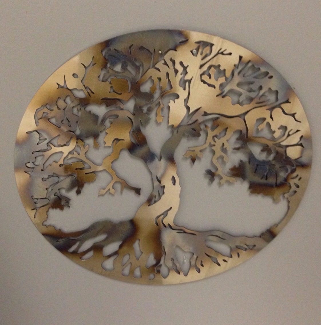 Round Tree of Life industrial metal wall art in heat tinted