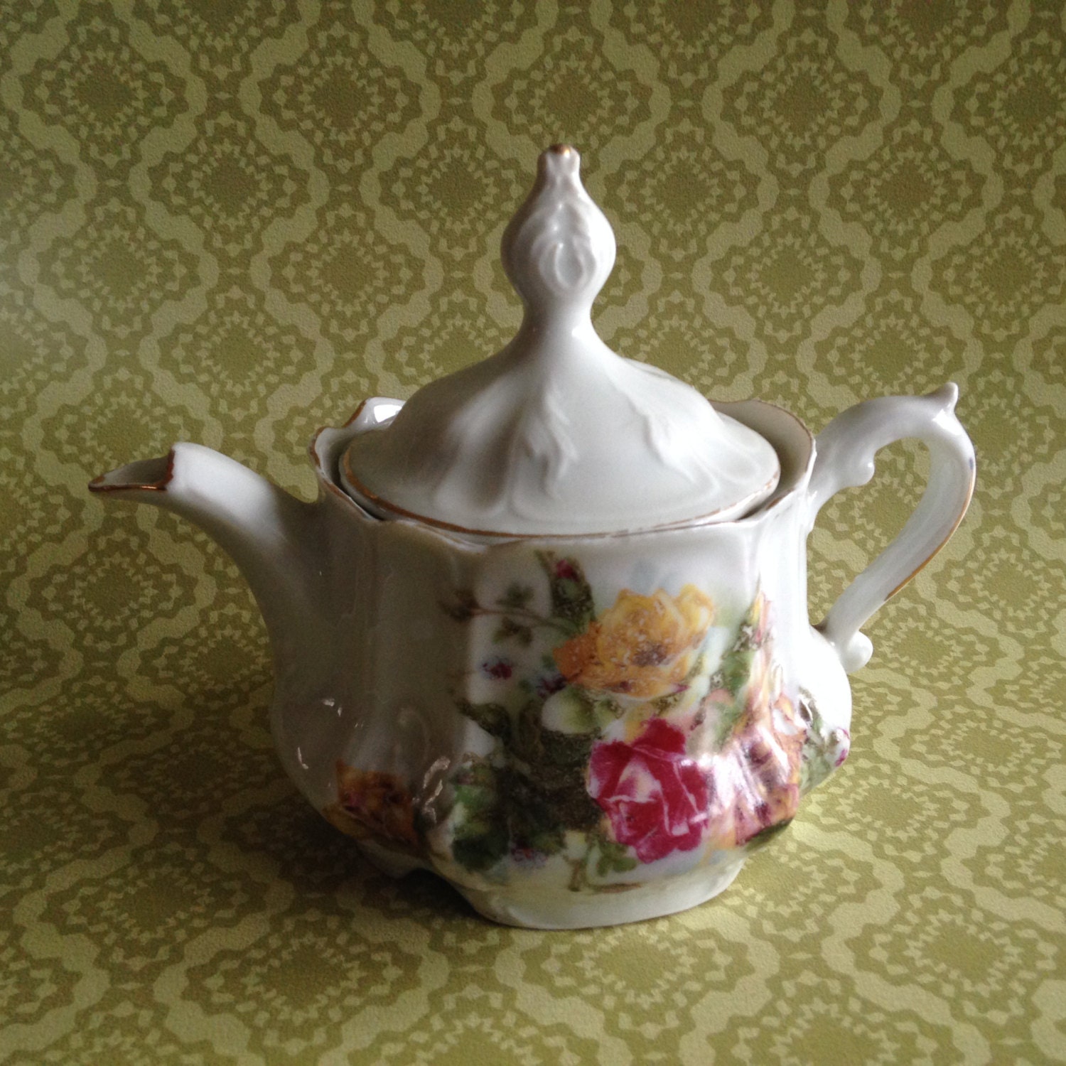 Vintage small ornate teapot with flowers and gold trim