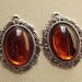 Vintage amber plastic cabochon pendants
