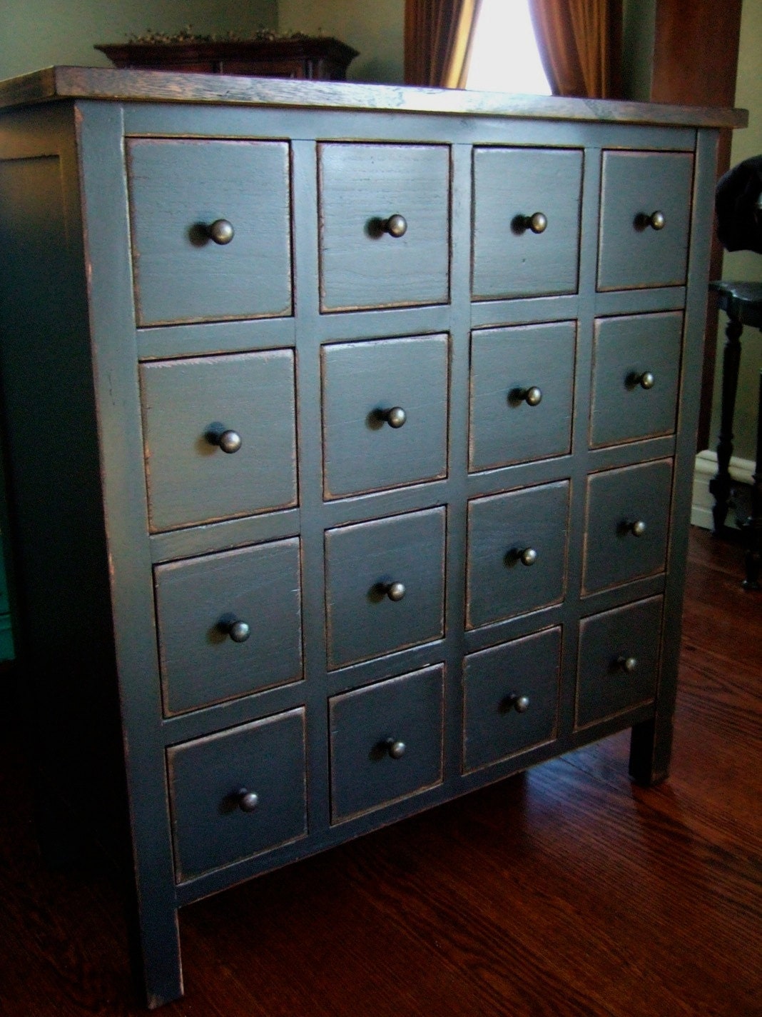 Apothecary Chest in a distressed black with wood stained top.